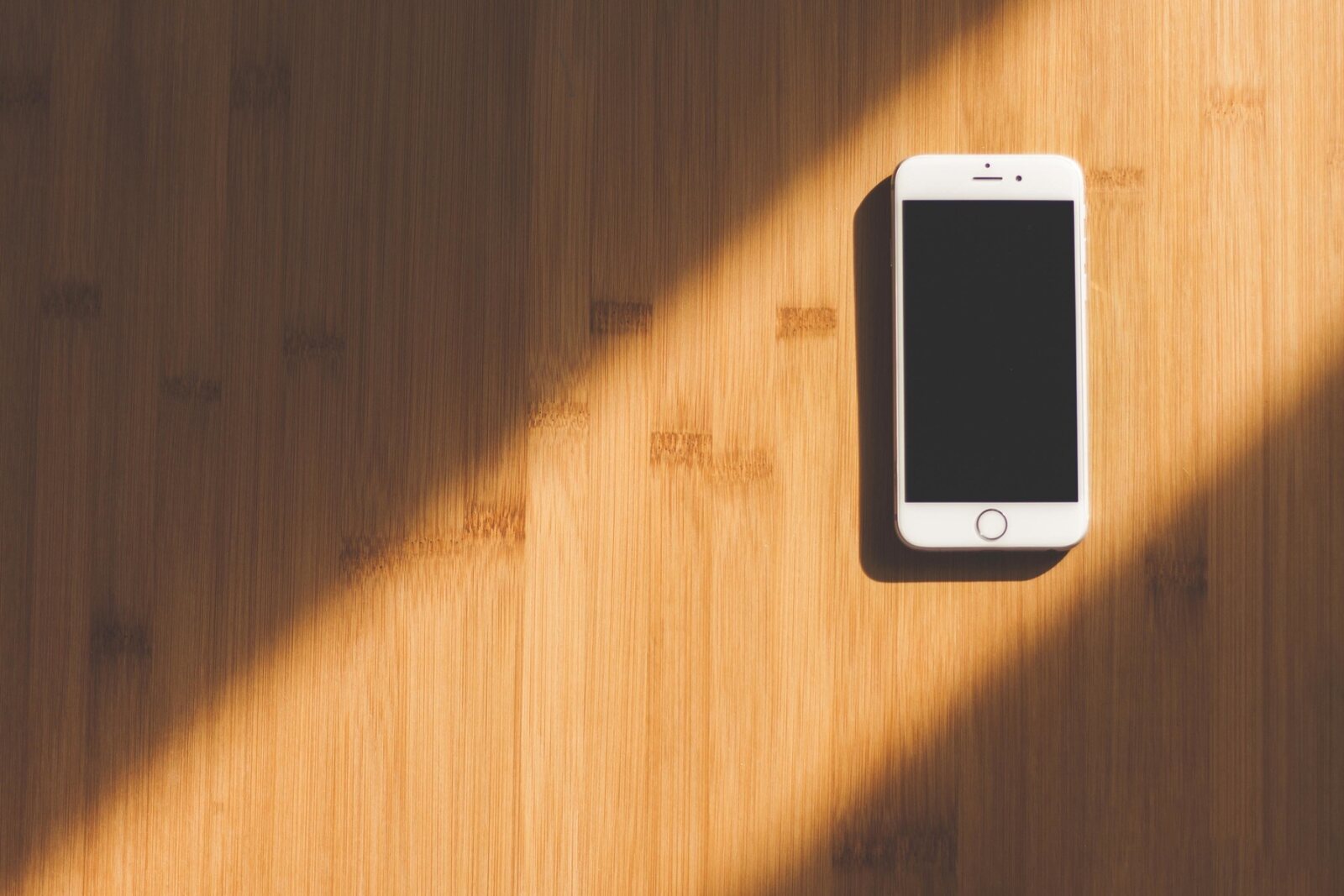 A quiet, private moment with a phone in warm light.